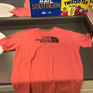 A medium coral colored north face t shirt
